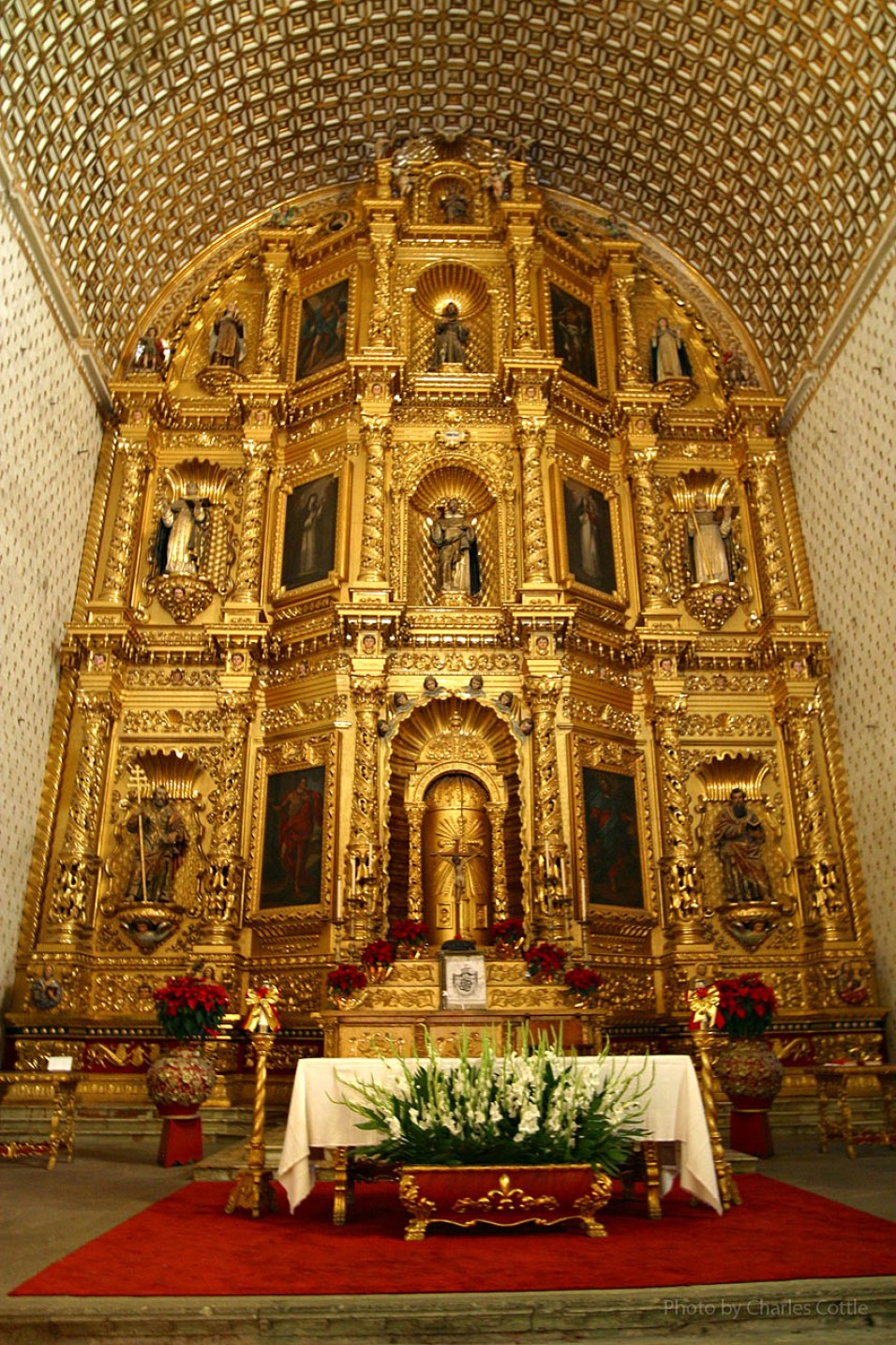 Ornate altar painted in gold plate from floor to ceiling